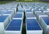 Używane panele fotowoltaiczne – czy tańszy start w energię słoneczną faktycznie się opłaca? Liczne czarne panele fotowoltaiczne zamontowane na dachu domu pod błękitnym niebem